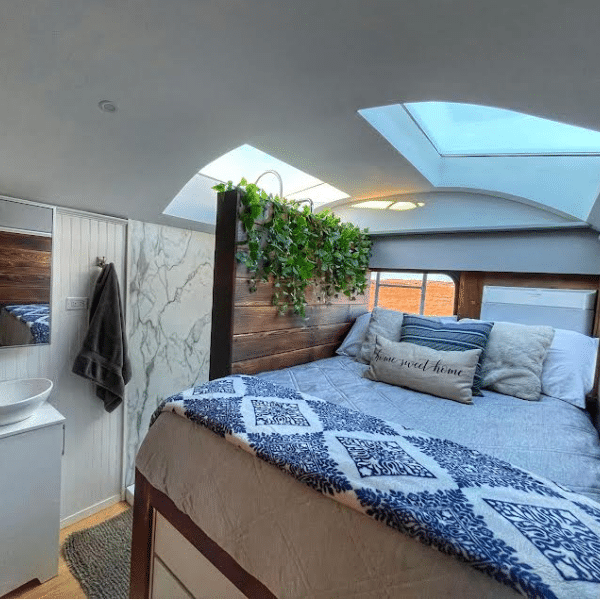 skoolie bedroom with huge skylights