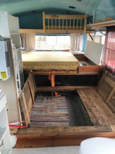 Upper bunk for kids or animals, or storage. Bed comes up. I used the tie down straps and upper bunk to raise bed and access storage. The entire area under bed is storage.