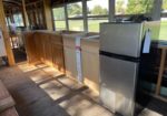 in the kitchen - this is the refrigerator  and cabinetry we bought. on the far right side you can see the horse tank tub we purchased for the bathroom