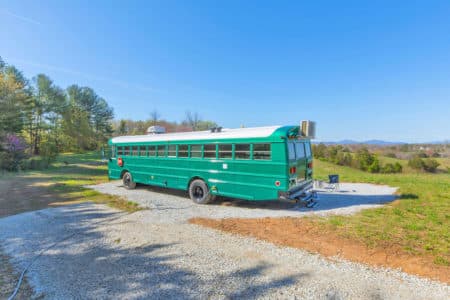 Mini split at back of bus, roof unit at front, tinted windows, and wood stove make the bus temperature control perfect. 30 amp electrical with 75 foot cord included in sale. All camping supplies (e.g., Solo Stove and chairs) included in sale.