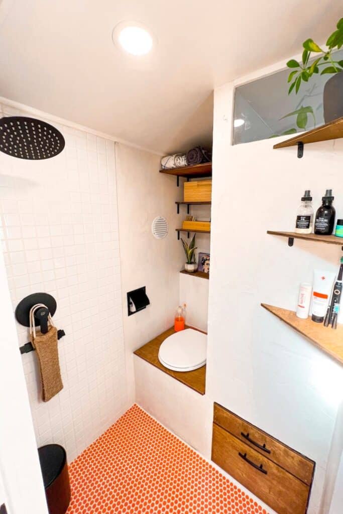 a skoolie shower toilet bathroom combo in one room