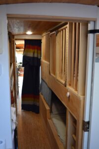 Twin bunk beds, top bunk configured as a crib