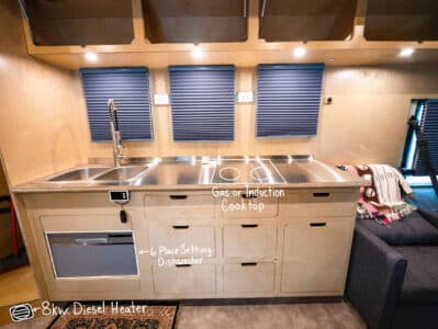 6 1/2 foot kitchen, custom cabinets made of one continuous piece of plywood cut by hand, with the overhead cabinets on display as well. The dishwasher holds 6 place settings, is more water efficient than washing by hand as well.